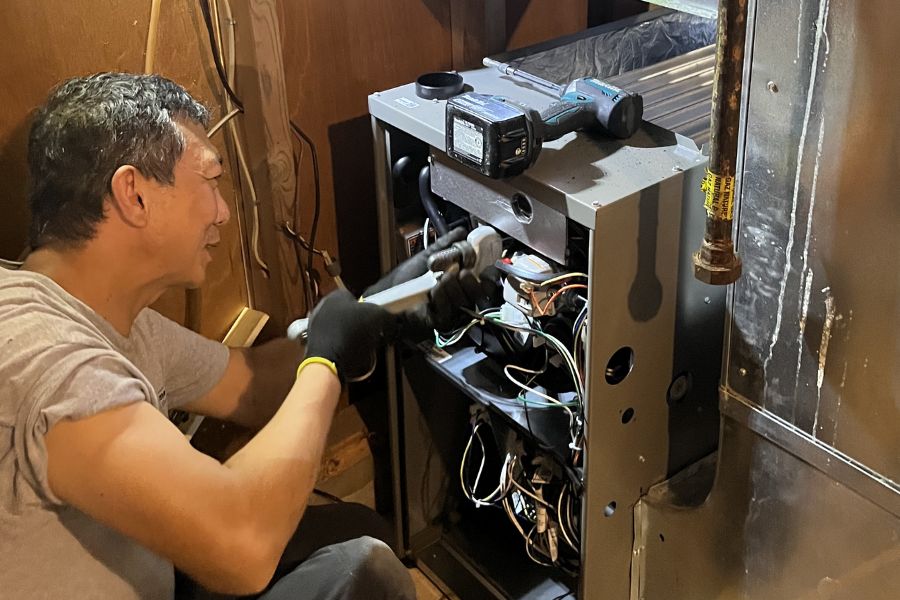 emergency gas furnace repair technician at work