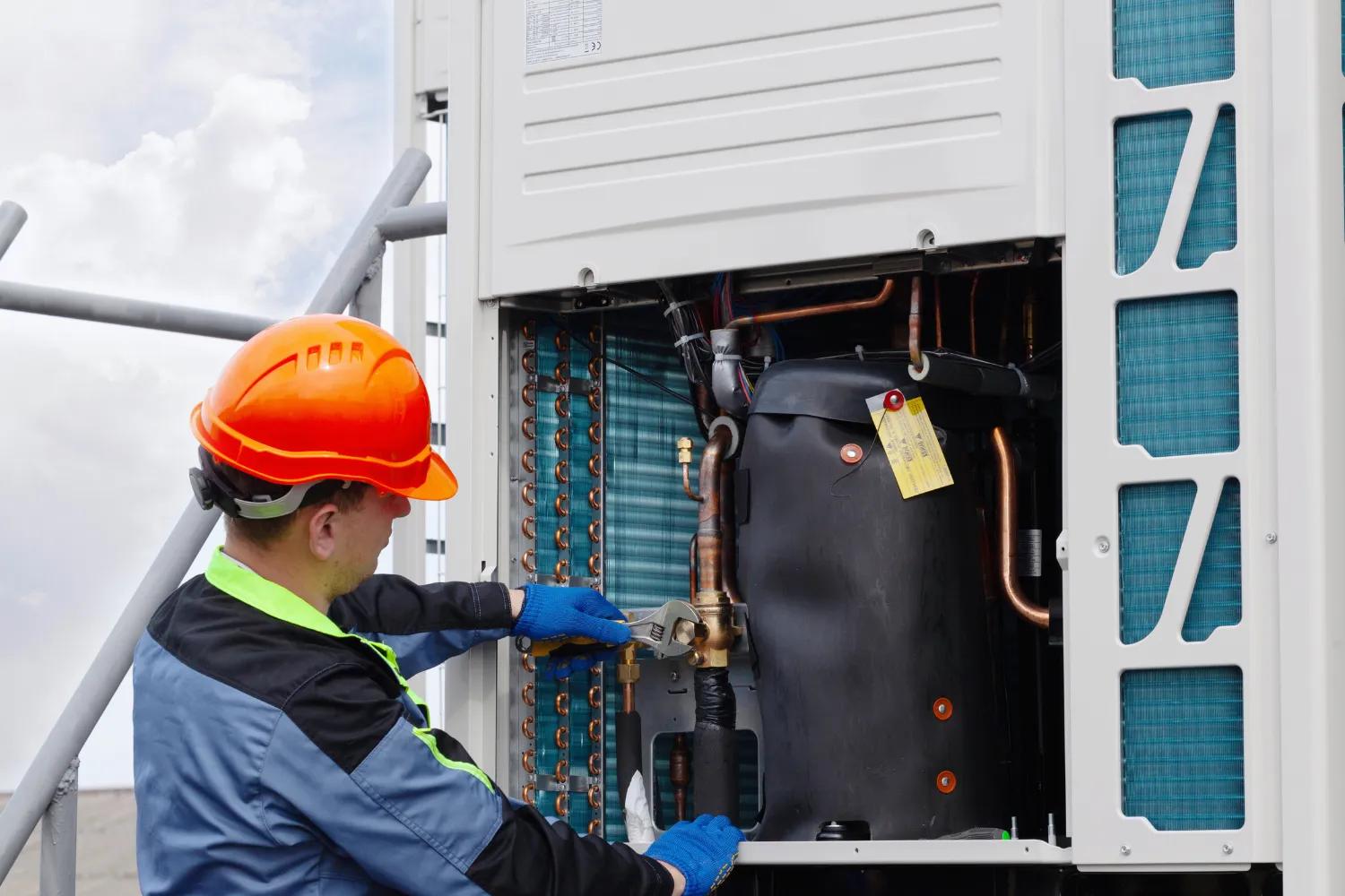 hvac technician checking cooling system