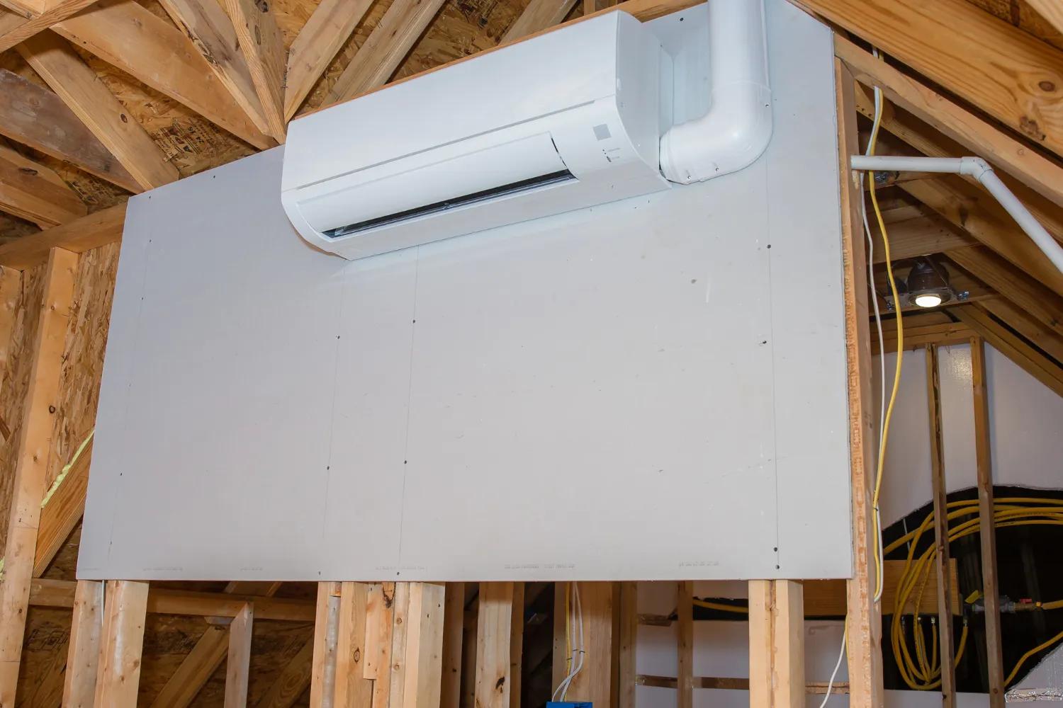 hvac technician installing wall mounted ductless air conditioner